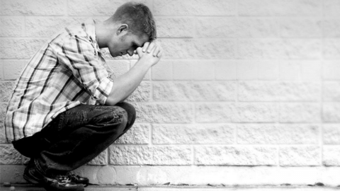Man crouching and praying